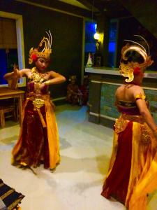 two women in costumes are dancing in a room at Amed Romance House in Amed