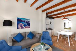 a living room with a couch and a table at TRH Tirant Playa in Fornells