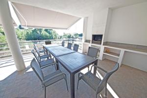 a dining room with a table and chairs on a balcony at Parabellum in L'Ampolla