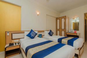 Postel nebo postele na pokoji v ubytování Hotel Mina International
