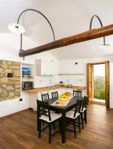 a kitchen and dining room with a table and chairs at Casa di Nonno Mariano in Motta Camastra