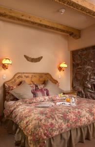a bedroom with a large bed with a stone wall at The Alpenhof in Teton Village