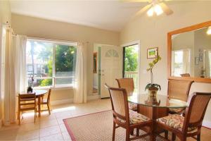 a dining room with a table and chairs and a window at Regency at Poipu Kai #924 in Koloa