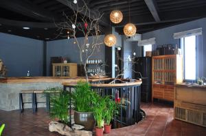 a restaurant with a table and some plants and lights at House of Ahan in Meishan