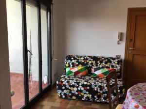 a couch with colorful pillows sitting in a room at Casa Piave in Scandicci