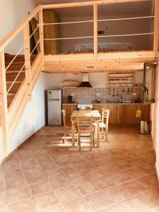a kitchen and dining room with a table and chairs at Seafront Studio with direct beach access in Koroni