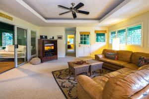 uma sala de estar com um sofá e uma ventoinha de tecto em Kauai Tree House em Wainiha