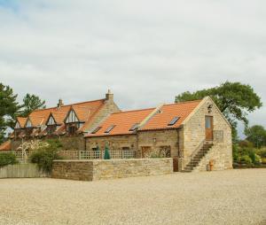 a large brick building with red roof at Badger Cottage in Scarborough