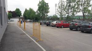 a parking lot with a lot of parked cars at Apartments R Sport boutique with free Parking in Sarajevo