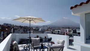 アレキパにあるLa Casa de Ana - Peruの山の景色を望むバルコニーに傘付きテーブル