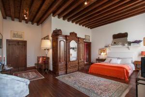 a bedroom with a bed and a large wooden cabinet at Villa Irene in Casale sul Sile +15 photos