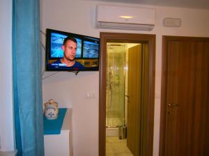 a flat screen tv on the wall of a bathroom at Room Vilma in Komiža