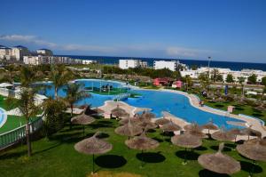 an aerial view of a resort with a pool and umbrellas at L'escale Appart-hôtel By 7AV HOTELS in M'diq