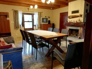 a dining room with a table and chairs and a fireplace at Agroturystyka Giże in Giże