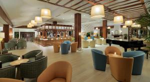 a lobby with a piano and chairs and a grand piano at Hotel Jardín Tecina in Playa de Santiago