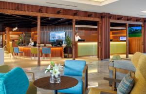 a lobby with a table and chairs and a bar at Hotel Jardín Tecina in Playa de Santiago