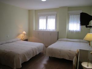 Posteľ alebo postele v izbe v ubytovaní Hostal El Estudio