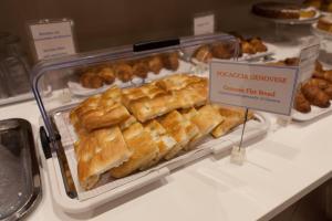 a display case in a bakery filled with bread at Hotel Tirreno in Genoa