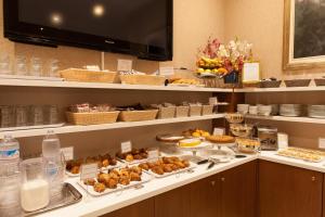 a buffet with many different types of food on a counter at Hotel Tirreno in Genoa