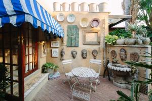 a patio area with chairs, tables and umbrellas at The Art Guesthouse in Hartbeespoort