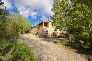 an old stone house on a dirt road at Agriturismo Corvaia in Radicofani