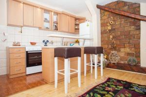 a kitchen with a counter and two bar stools at Apartment Markale in Sarajevo