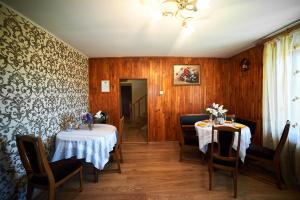 a dining room with two tables and chairs at Green Hill in Lviv