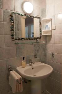 a bathroom with a sink and a mirror at Spacious balcony apartment Piran in Piran