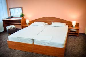 A bed or beds in a room at Family Hotel Varna