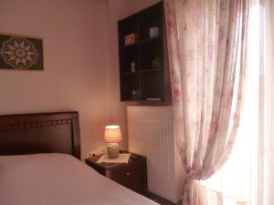 a bedroom with a bed and a window at Dream House in Iraklitsa