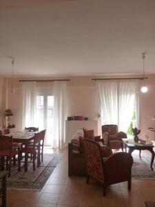 a living room with a table and a dining room at Dream House in Iraklitsa