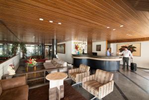 a man with a suitcase standing in a lobby at Xênius Hotel in João Pessoa +45 photos