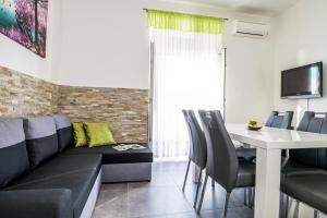 a living room with a couch and a table at Apartment Stefania on the beach in Koromačno