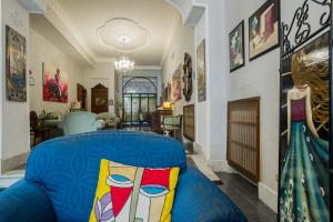 a living room with a blue couch with a colorful pillow at Hotel Residenza In Farnese in Rome