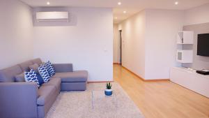 a living room with a couch and a table at Ana's Apartments in Sines