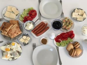 a white table with plates of food on it at Kutaisi Grand Suites in Kutaisi
