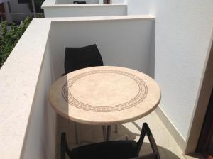 a small table and chairs in a small room at Hotel Corallo in Torre Santa Sabina