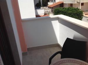 a view of a balcony with a chair at Hotel Corallo in Torre Santa Sabina