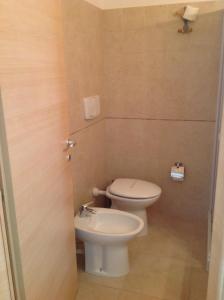 a small bathroom with a toilet and a sink at Hotel Corallo in Torre Santa Sabina