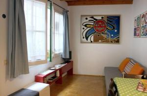 a living room with a bed and a window at Mini Apartamento Port Aiguadolç in Sitges