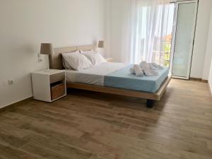 A bed or beds in a room at Alegria Kefalonia