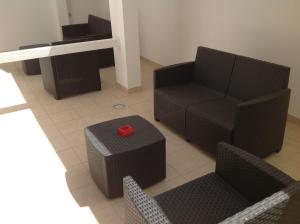 a living room with a chair and a table at Hotel Corallo in Torre Santa Sabina