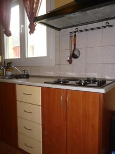 a kitchen with a stove and a sink and a window at Dream House in Iraklitsa +36 photos