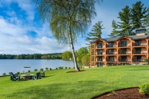 a large building on the shore of a lake at Center Harbor Inn in Center Harbor