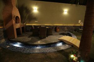 a patio with a table and chairs in a building at Dorrah Resort in Riyadh