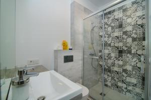 a bathroom with a sink and a glass shower at Family apartments 2 in Vilnius