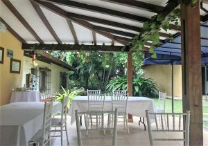 a white table and chairs under a pergola at Hotel Poblado Campestre in Medellín