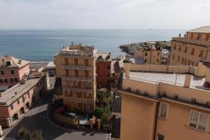 an aerial view of a city with the ocean at Hotel Tirreno in Genoa