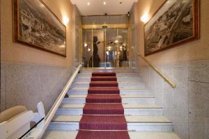 a staircase in a building with a red carpet at Hotel Tirreno in Genoa