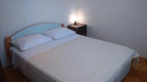 Postel nebo postele na pokoji v ubytování Apartmani Petra